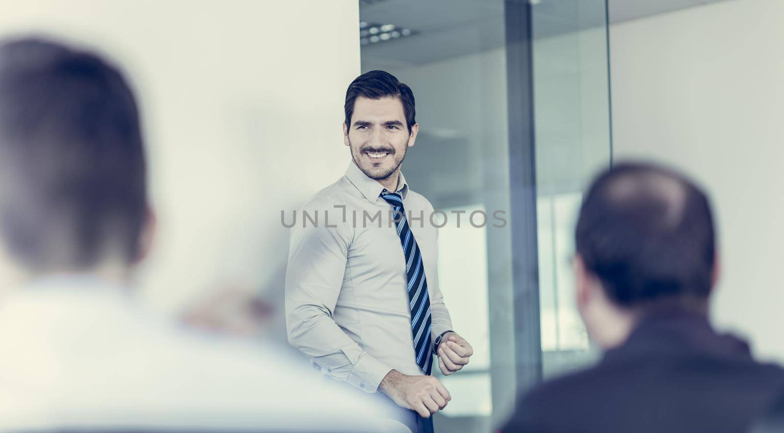 Relaxed cheerful team leader and business owner leading informal in-house business meeting. Business and entrepreneurship concept.