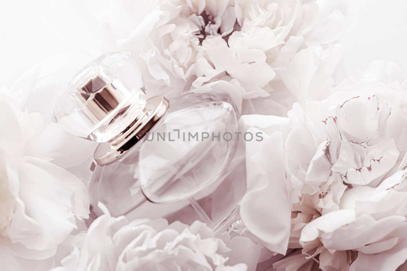 Chic fragrance bottle as luxe perfume product on background of peony flowers, parfum ad and beauty branding design