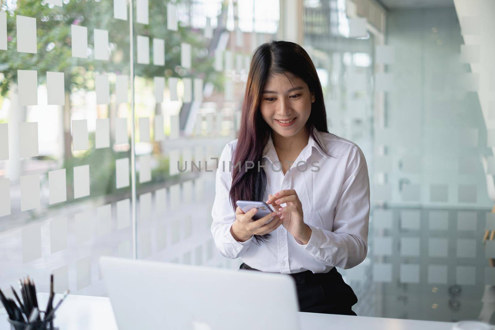 A businesswoman completes KYC using an online banking program in order to open a digital savings account. The definition of cyber security