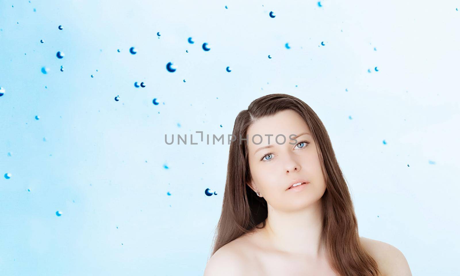 Rejuvenation skincare and beauty ad, beauty face portrait of young woman with healthy clean skin, blue cosmetic liquid drops on background.