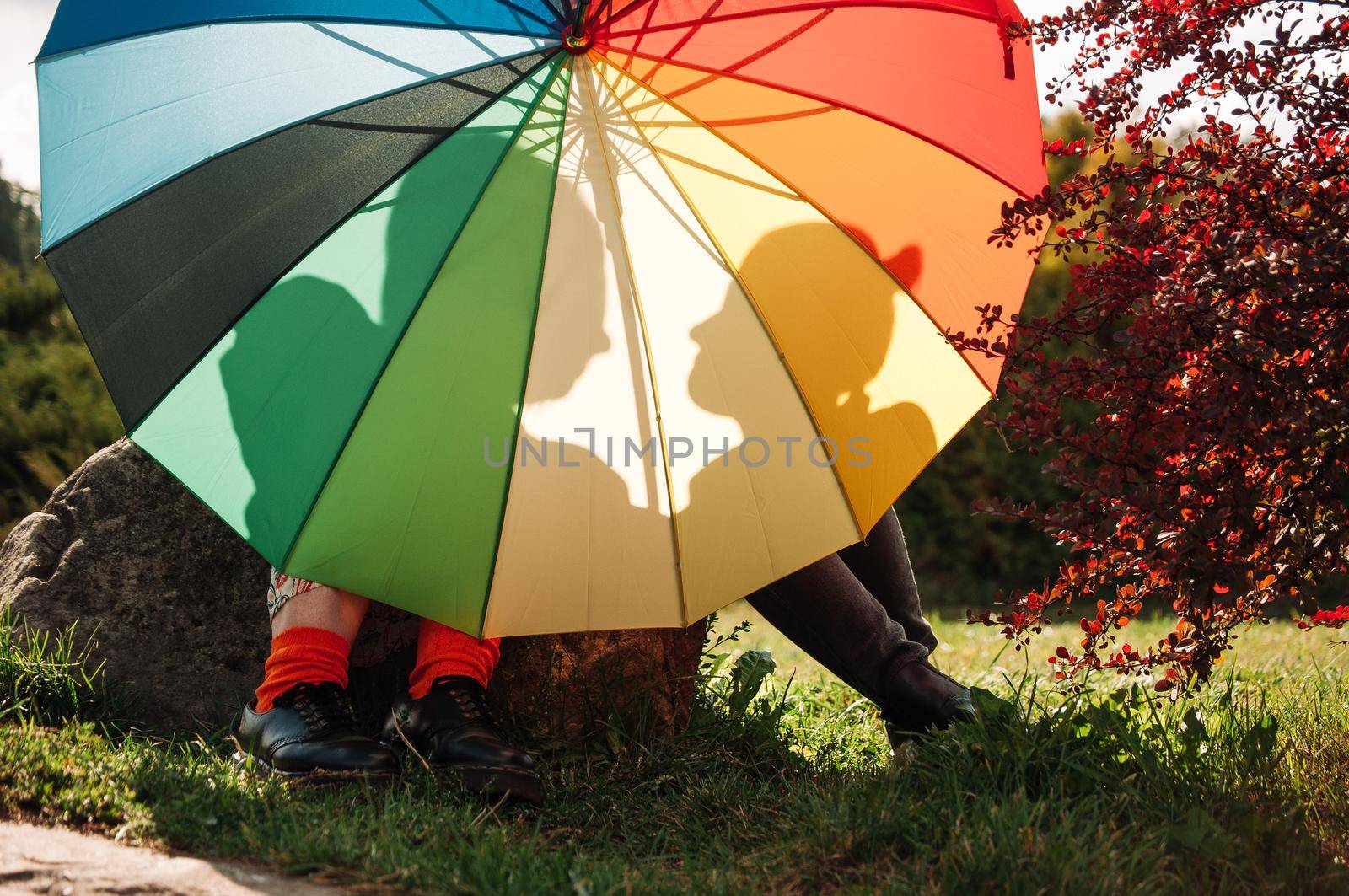 young couple of girls. Girls in love with lgbt umbrella. Two kissing girls Concept. Silhouette of two girls in love.
