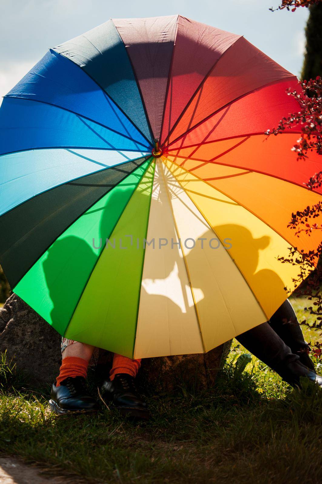 young couple of girls. Girls in love with lgbt umbrella. Two kissing girls Concept. Silhouette of two girls in love.