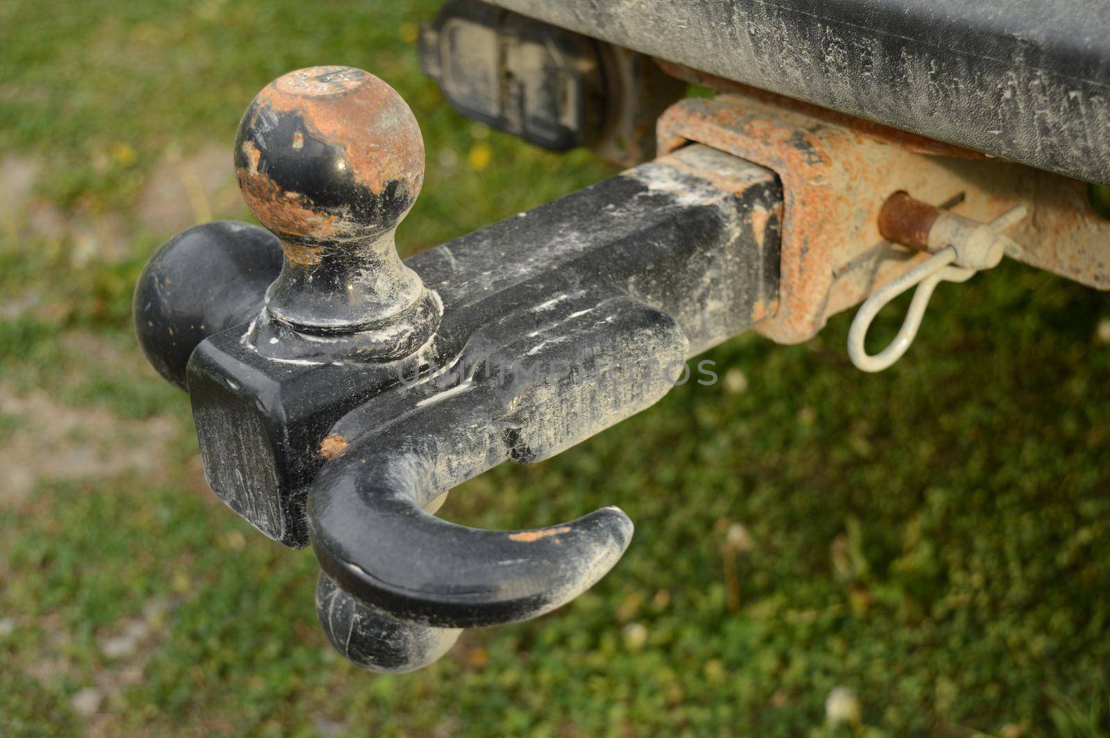 A closeup view of an attached trailer hitch on a vehicle for towing loads behind.