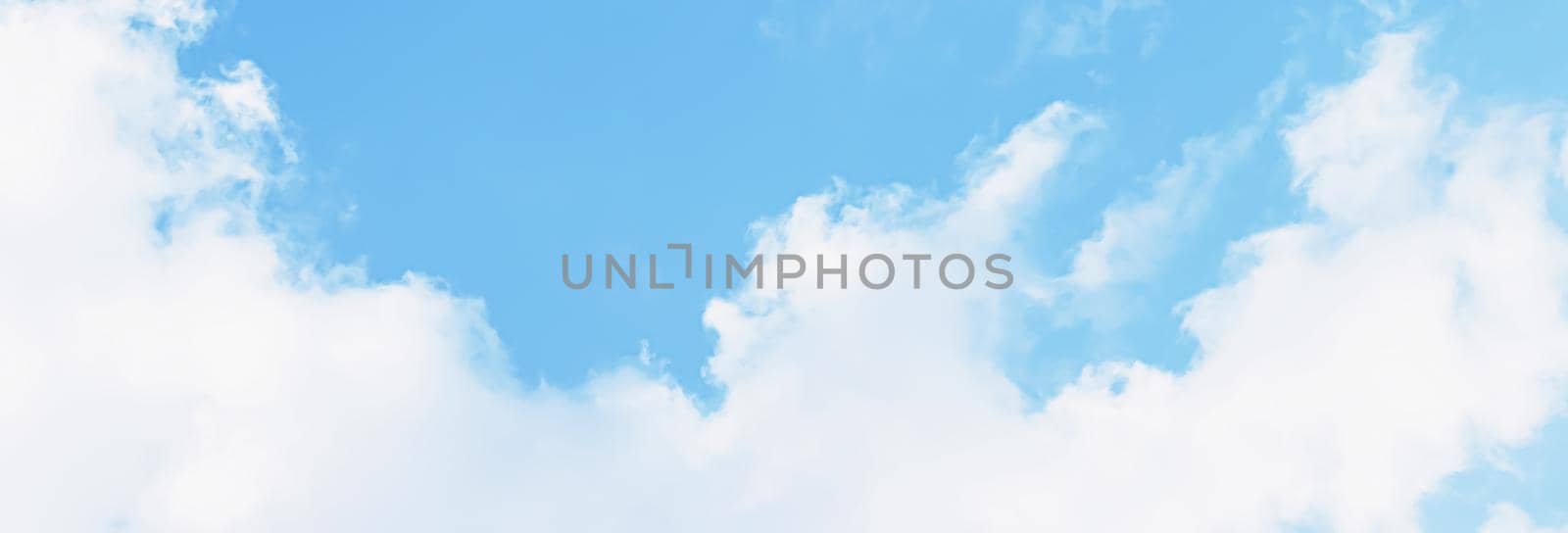 Blue sky background, white clouds and bright sunlight.