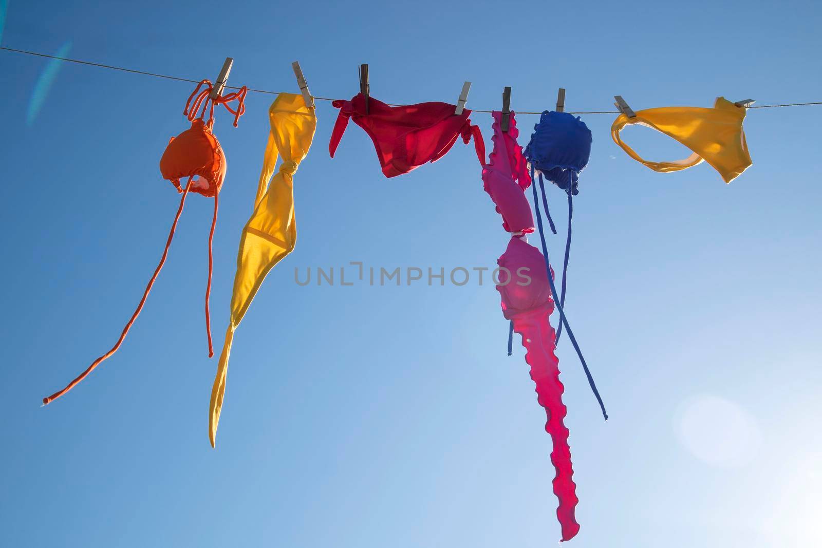 Swimwear of various colors lying in the sun  by fotografiche.eu
