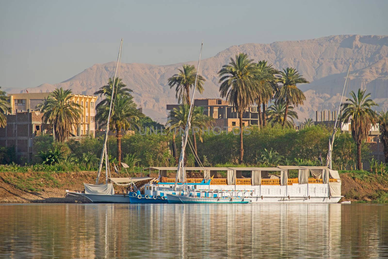 Large luxury traditional Egyptian dahabeya river cruise boat moored on the Nile