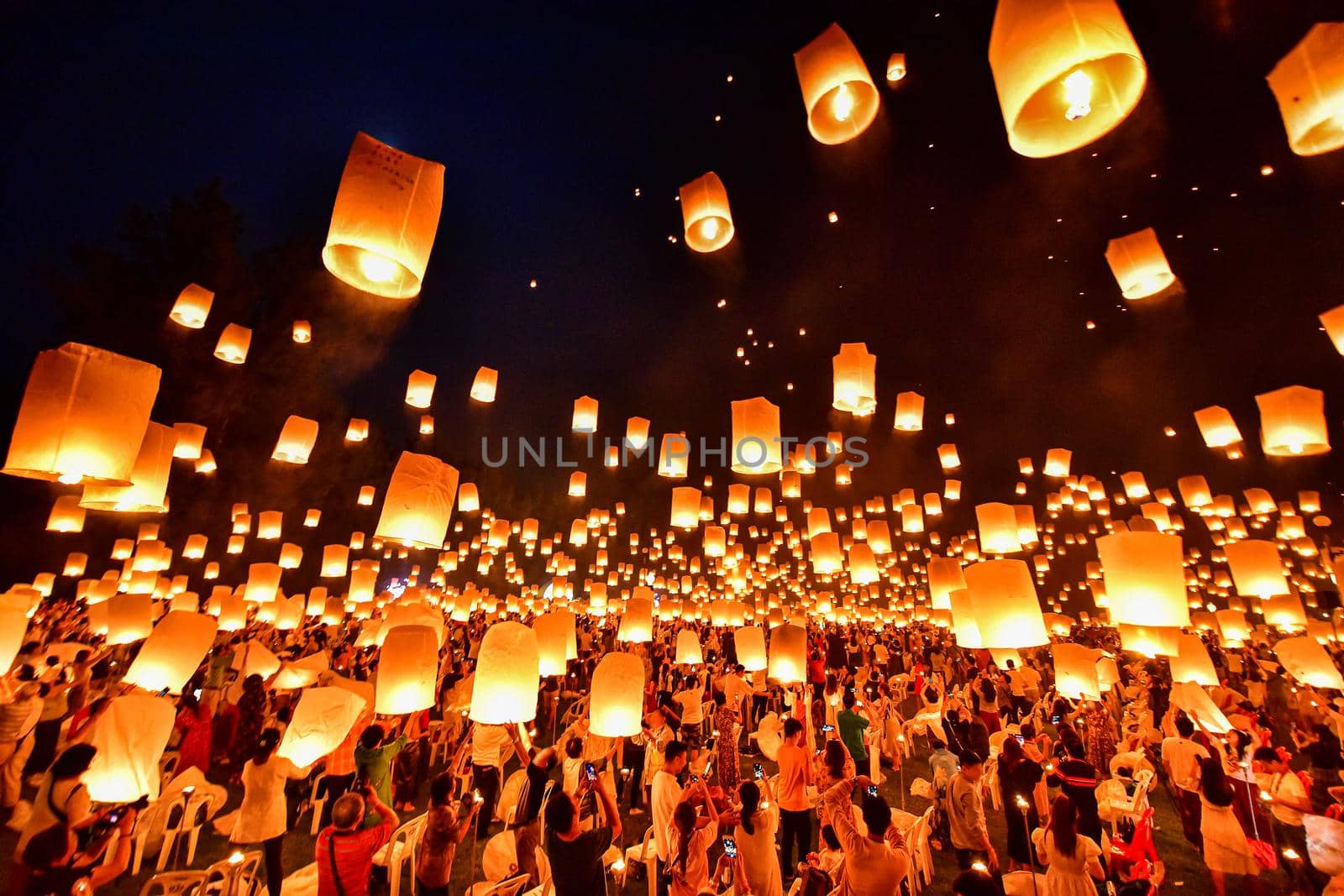 Floating lanterns on sky in Loy Krathong Festival or Yeepeng Festival , traditional Lanna Buddhist ceremony in Chiang Mai, Thailand