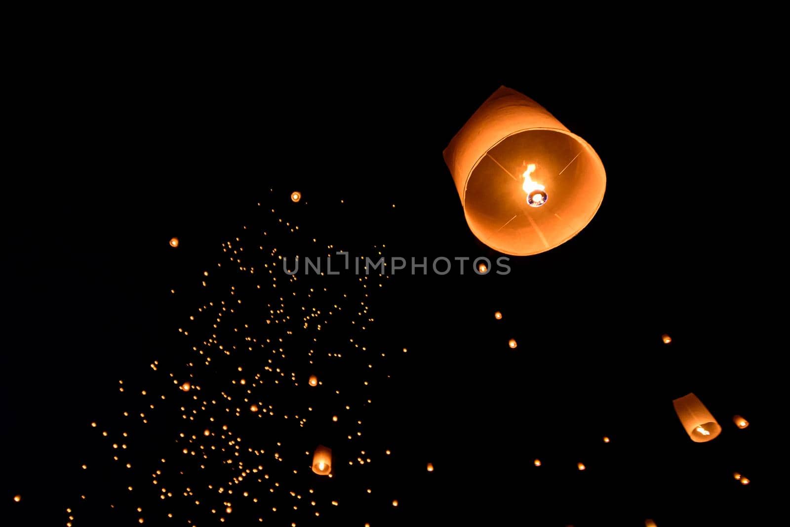 Floating lanterns on sky in Loy Krathong Festival or Yeepeng Festival , traditional Lanna Buddhist ceremony in Chiang Mai, Thailand