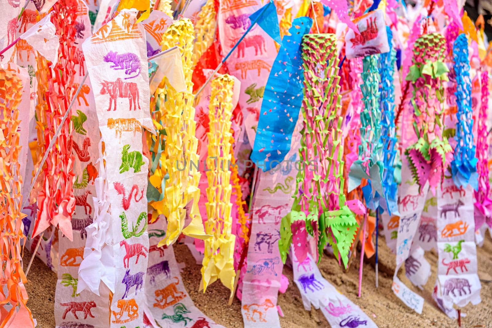 Paper flag on the pile of sand or Sand pagoda in Songkran festival at Temple in Muang, Chiang Mai, Thailand by NuwatPhoto