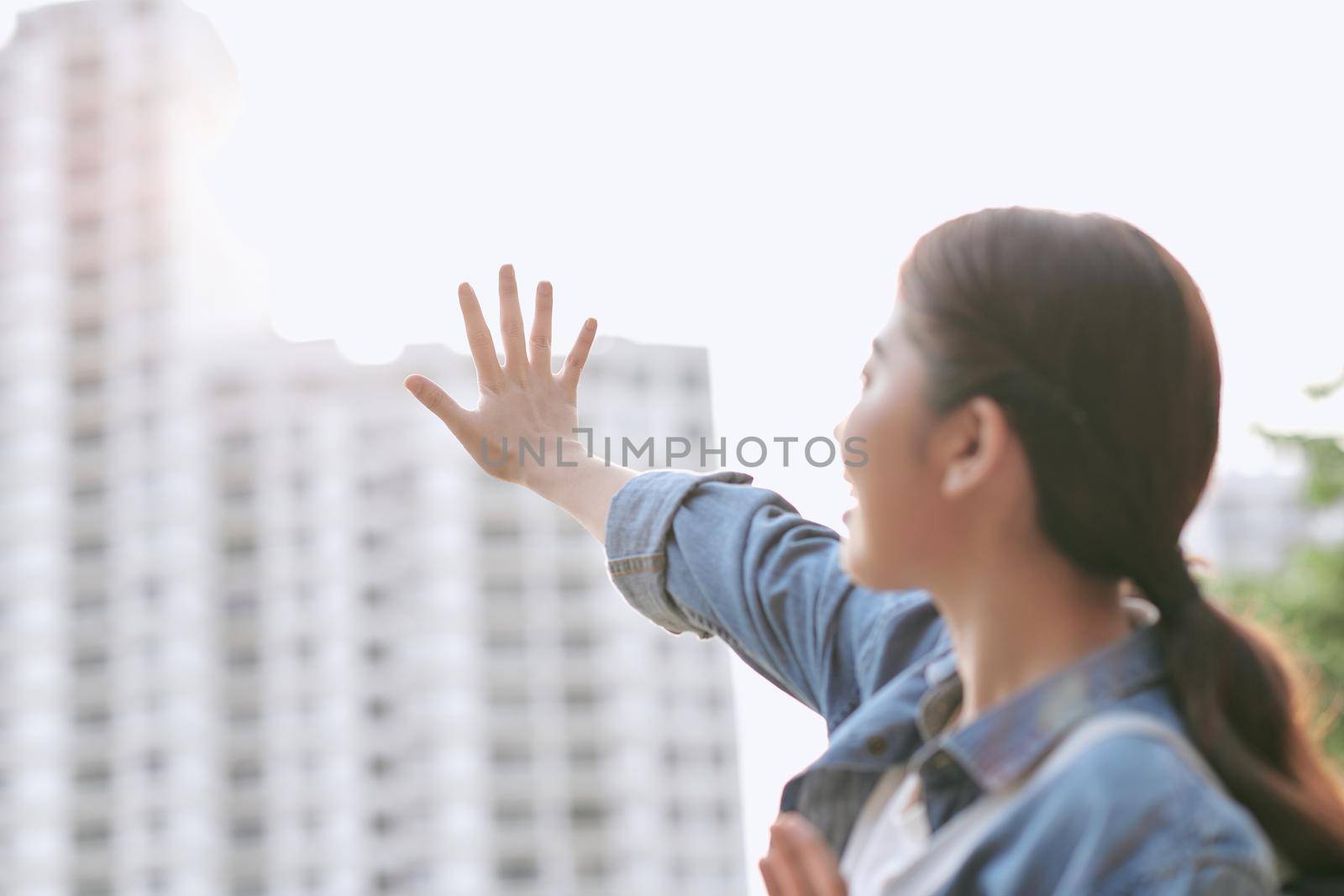 Sunny lifestyle fashion portrait of young stylish hipster woman walking on the street