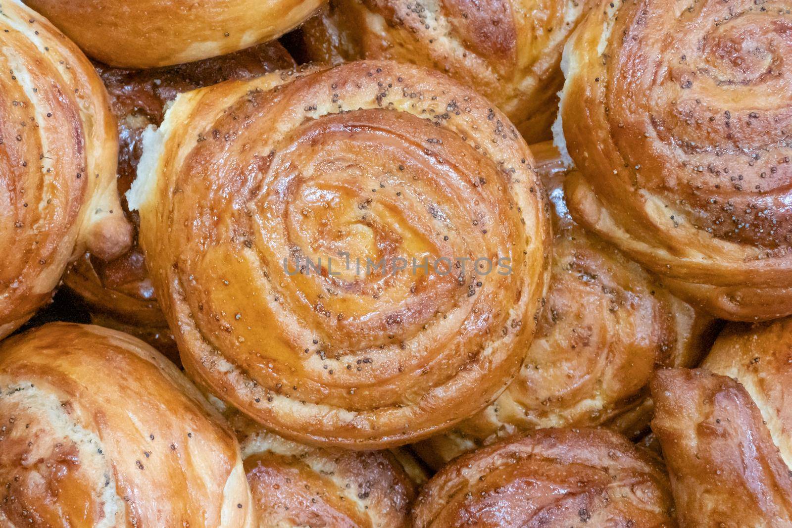 Fresh homemade round buns with poppy seeds. Russian traditional food. Top-view, close-up