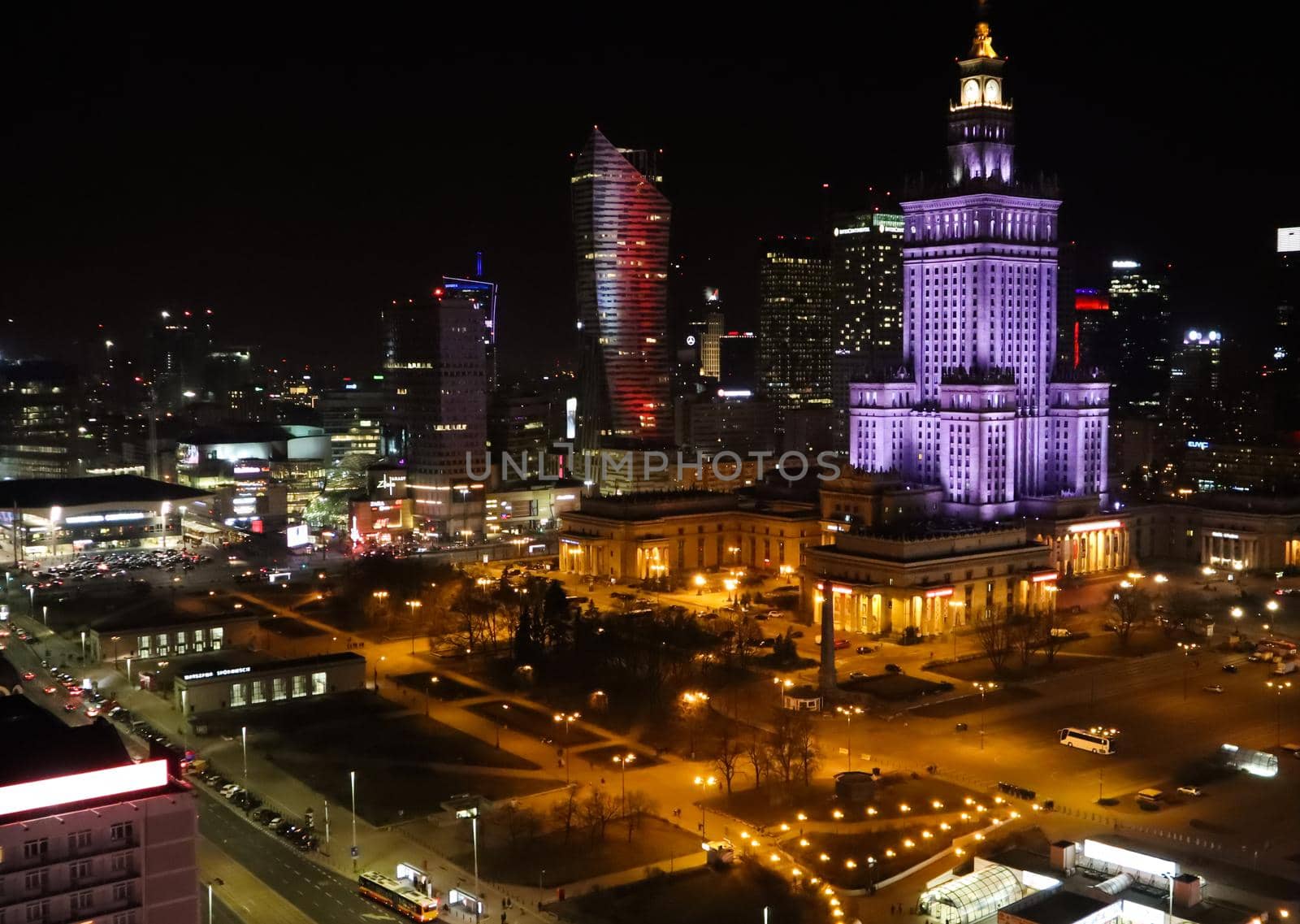 Warsaw / Poland - March 2019: Aerial view of the city center at night. Palace of Culture and Science and Business Skyscrapers