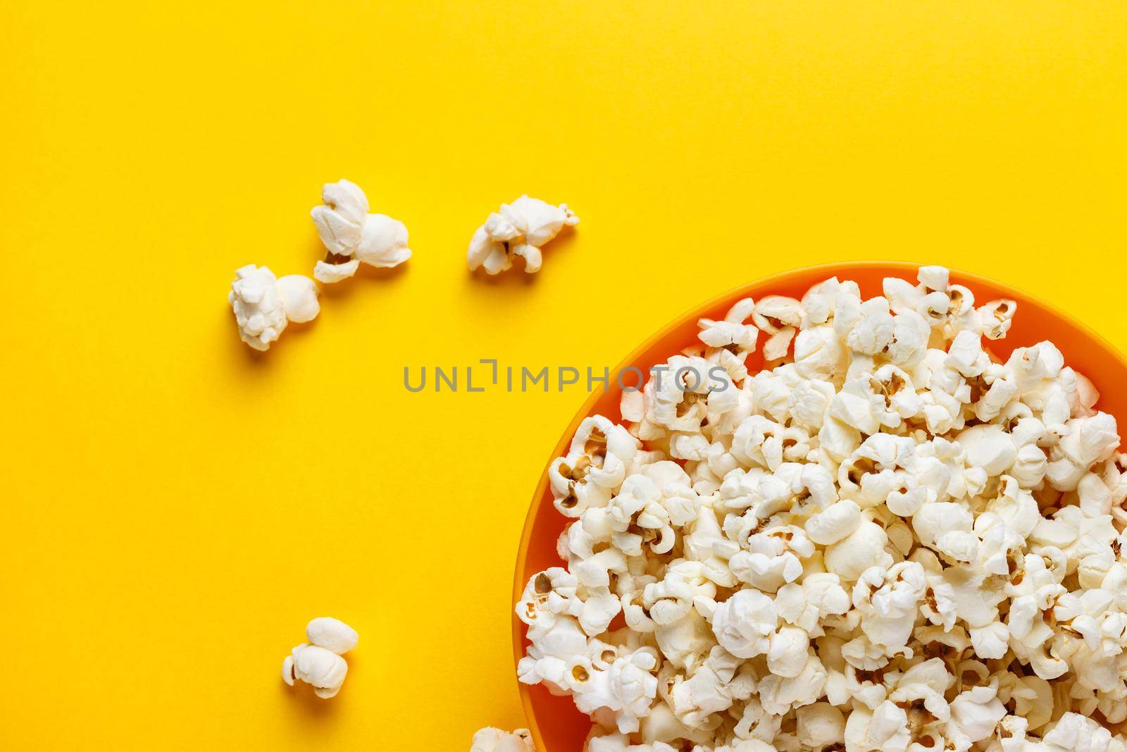 Popcorn in an orange bowl. by elxaval
