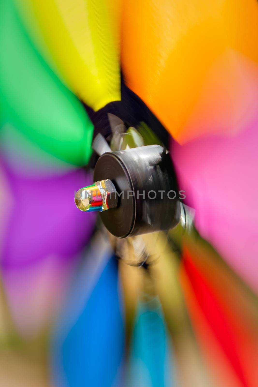 Colorful pinwheel spinning rapidly in the garden.