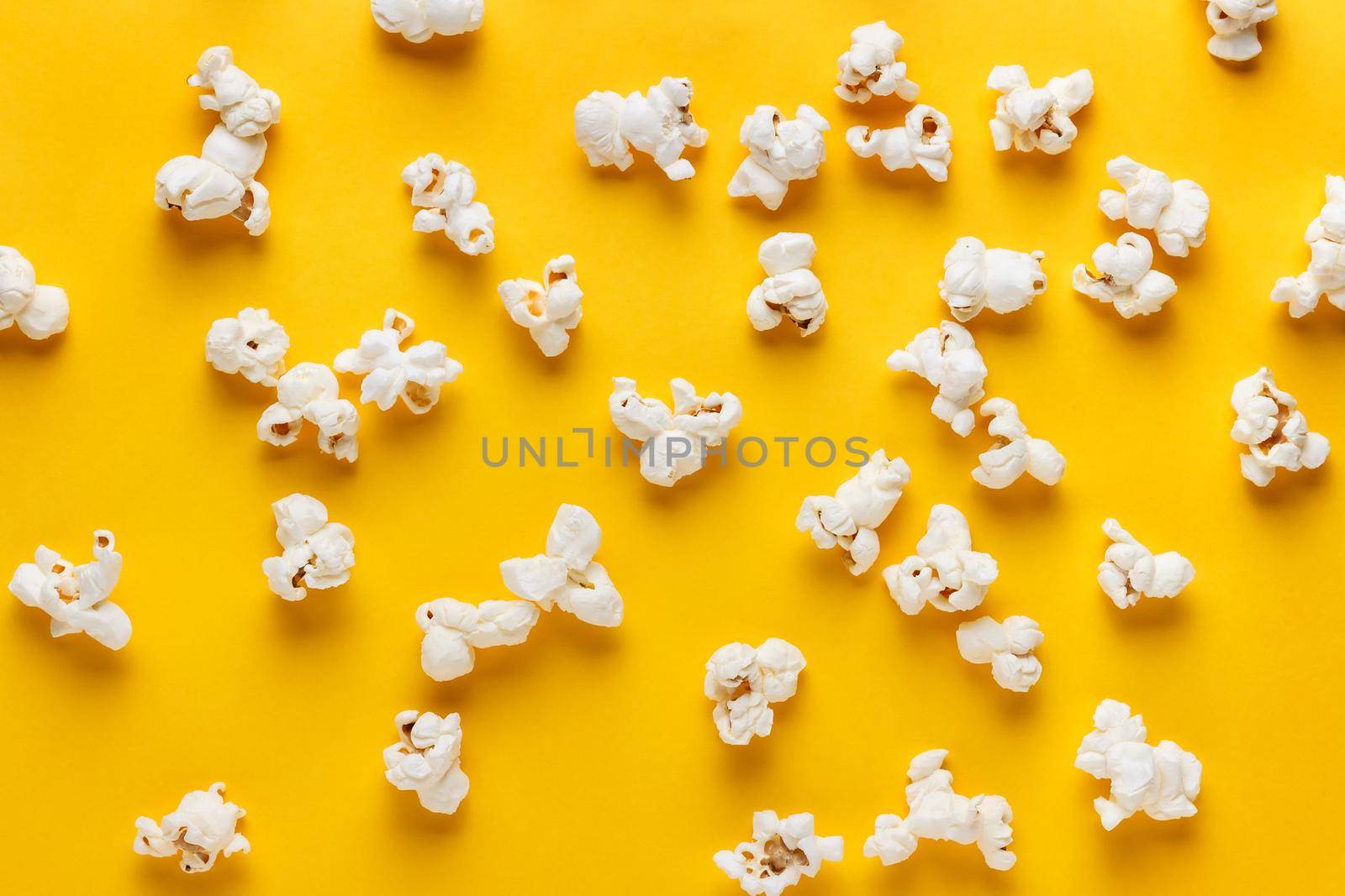 Popcorn on a yellow background. Horizontal image. Top view.