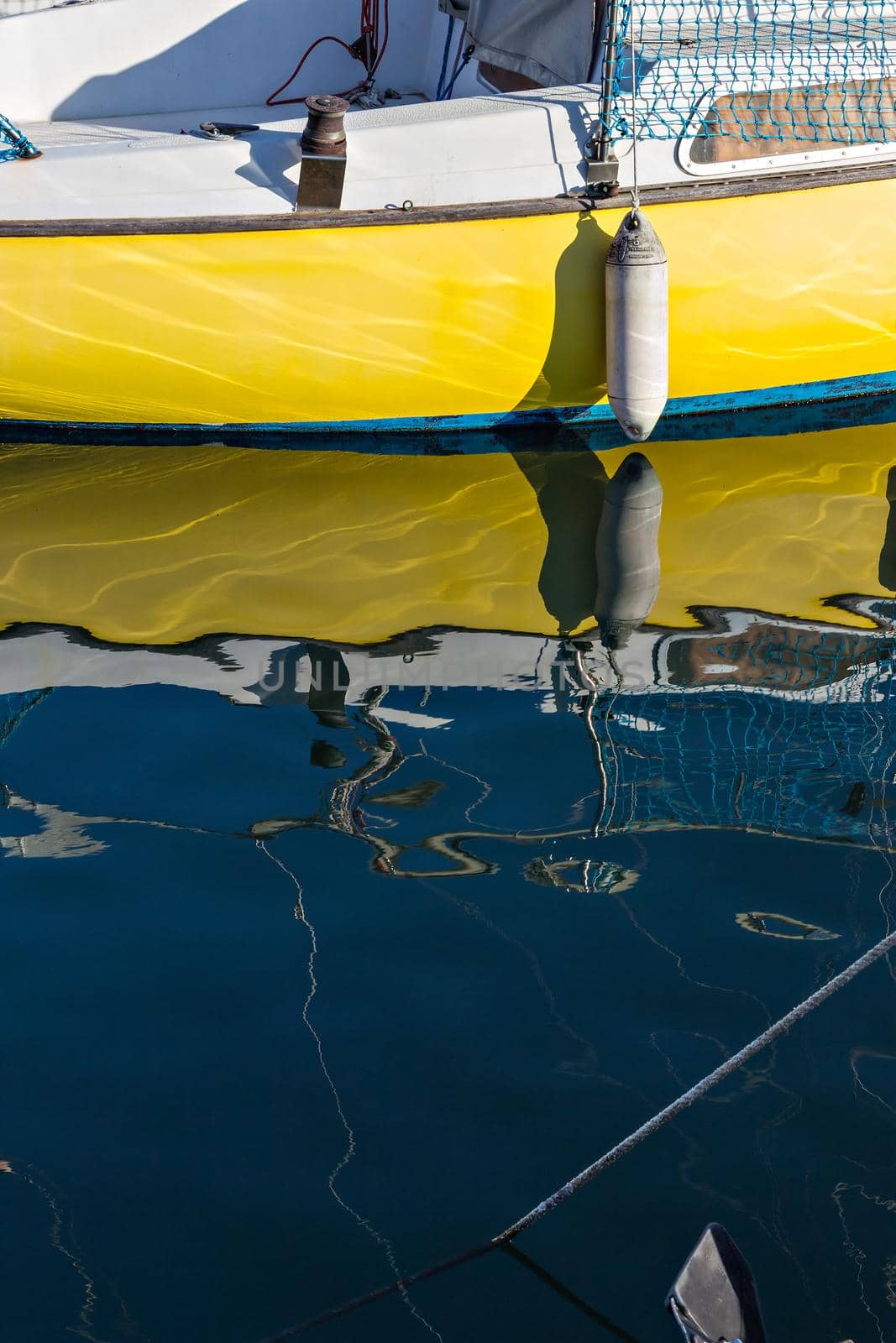 Pleasure boat with reflections in the water in the marina.