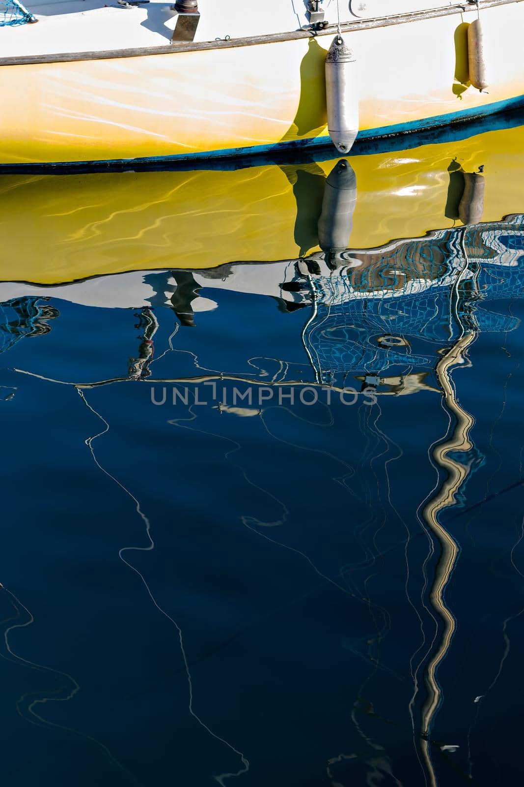 Pleasure boat with reflections in the water in the marina.