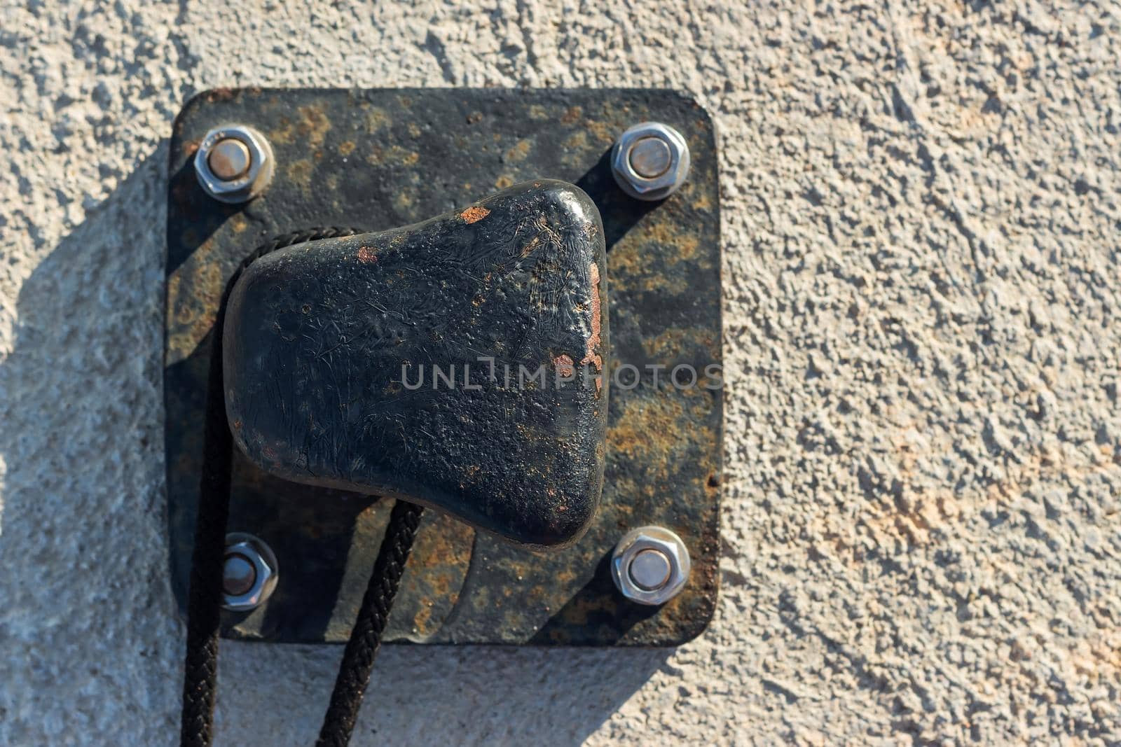 Close up iron pier with rope tied on the pier.