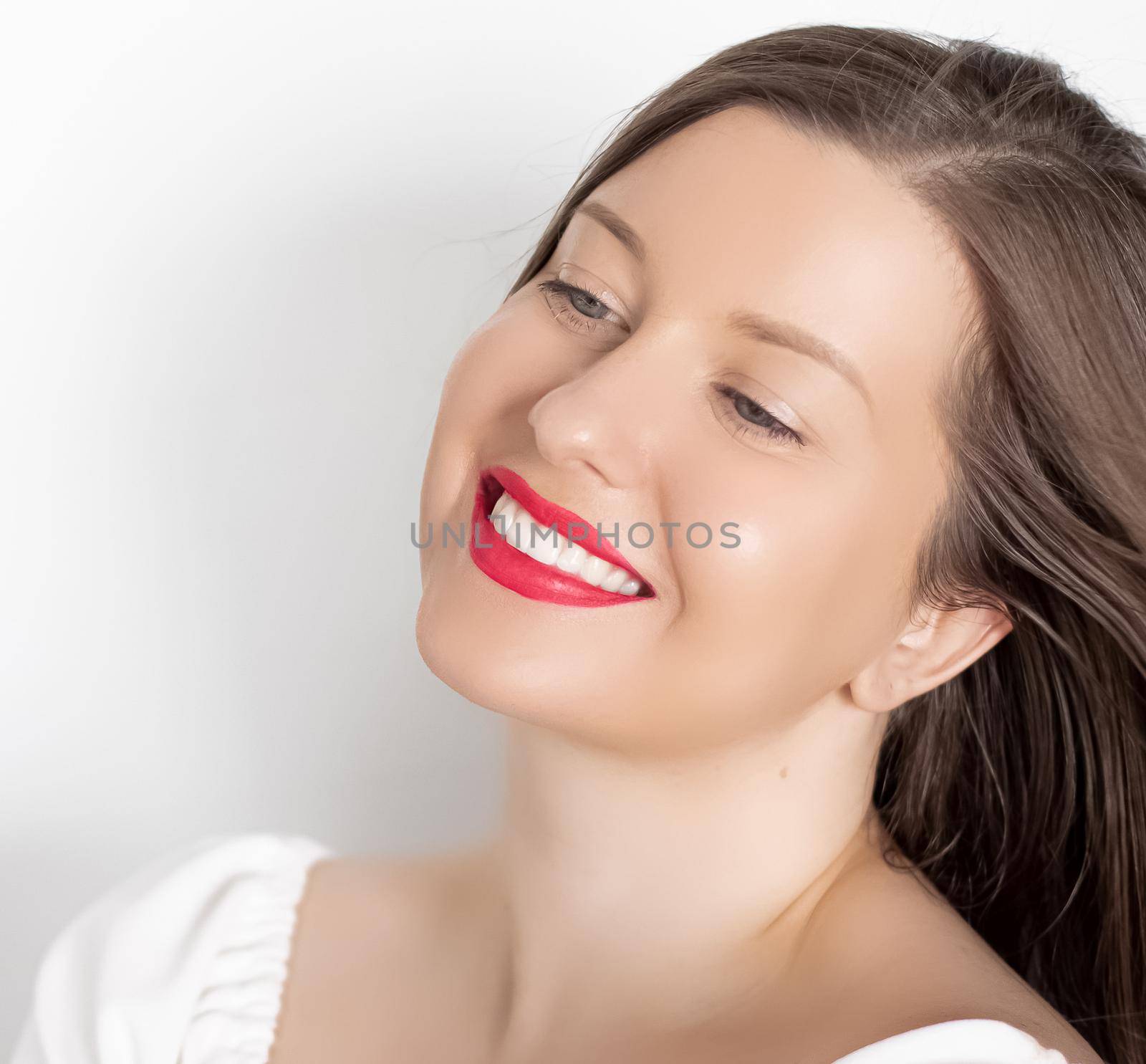 Happy smiling young woman with perfect white teeth and beautiful healthy smile, clean skin and natural makeup, female face portrait with positive emotion, beauty, wellness and skincare ad.