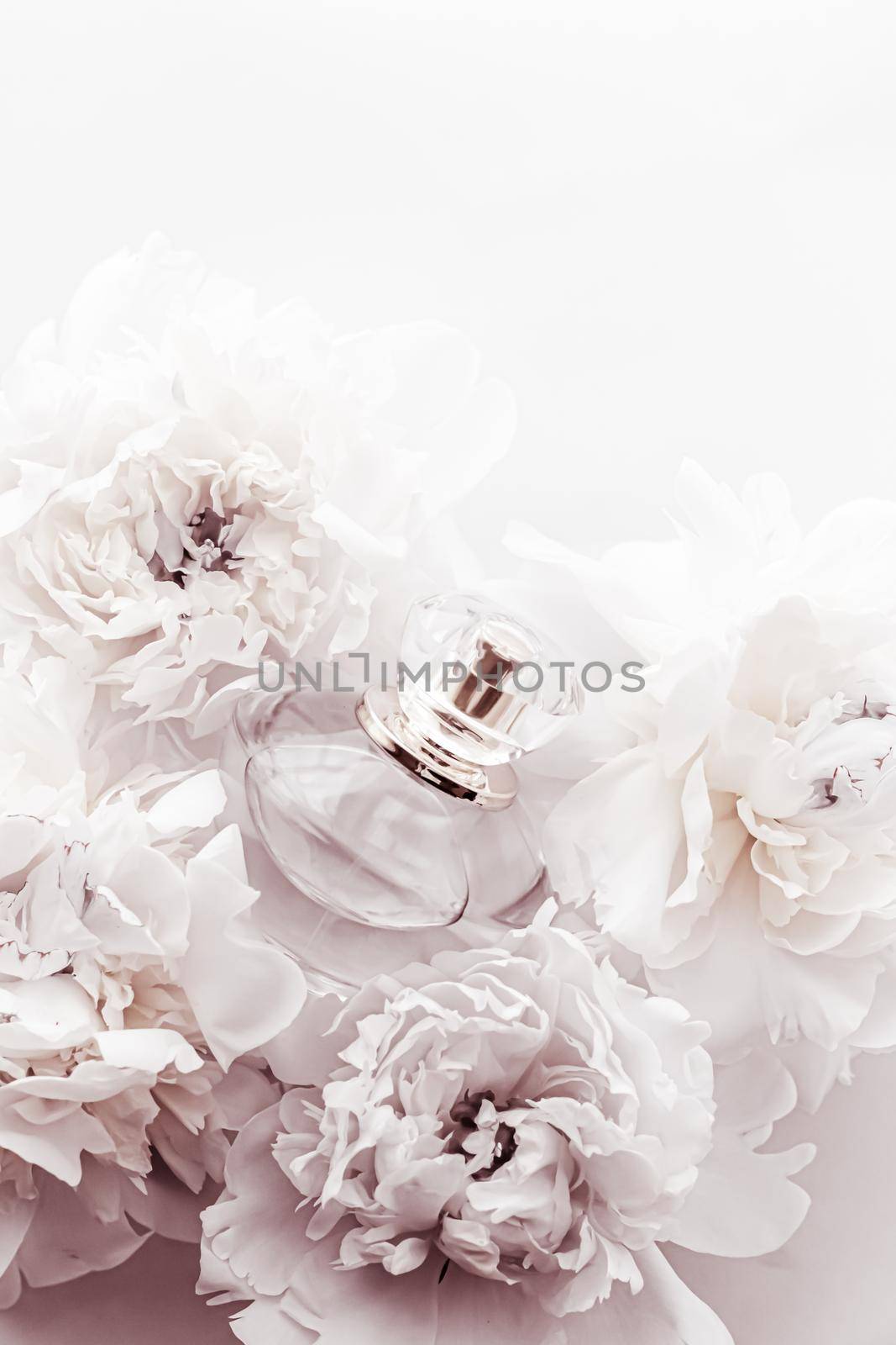 Chic fragrance bottle as luxe perfume product on background of peony flowers, parfum ad and beauty branding design