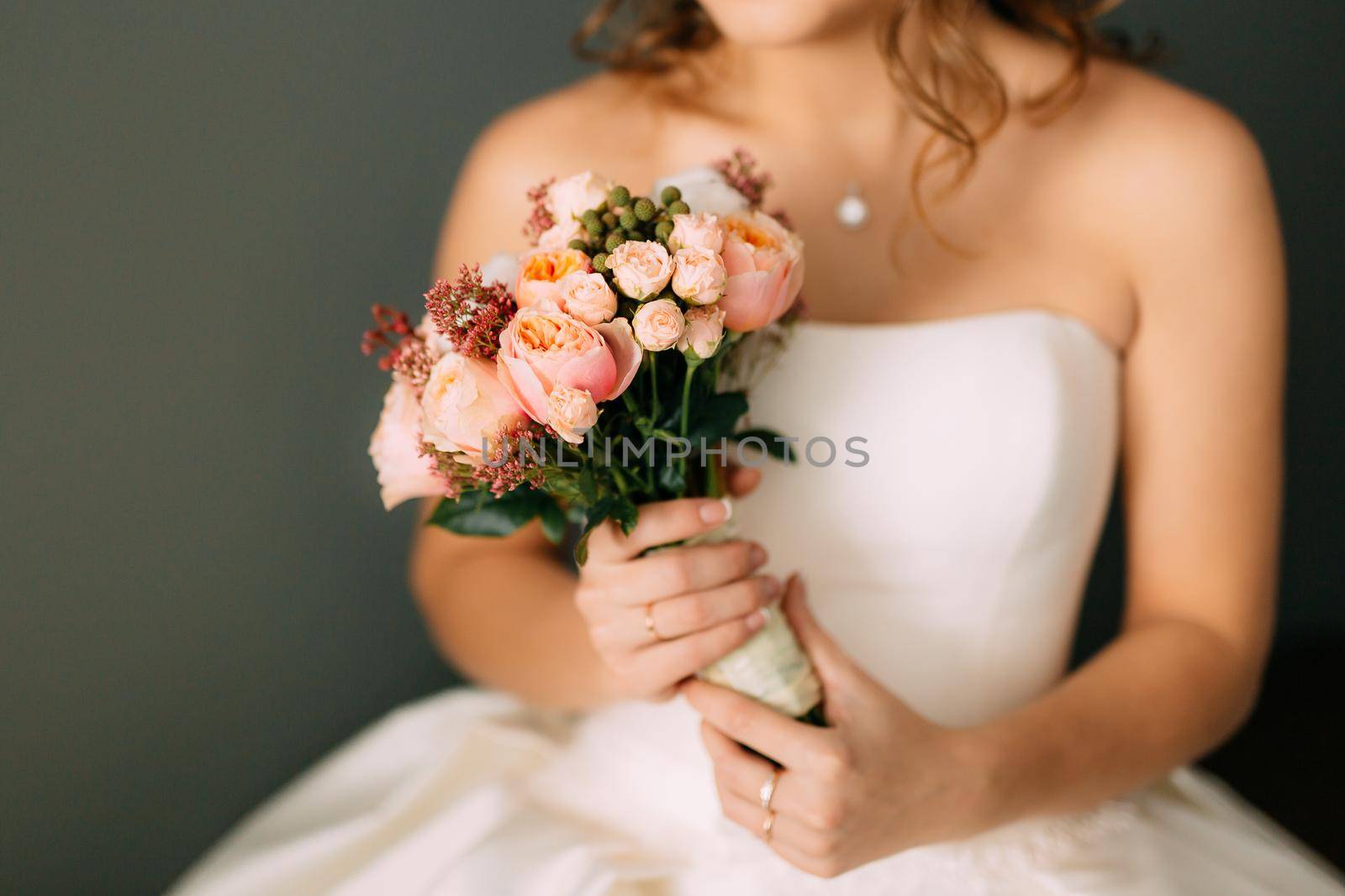 Wedding bouquet in hands of the bride by Nadtochiy