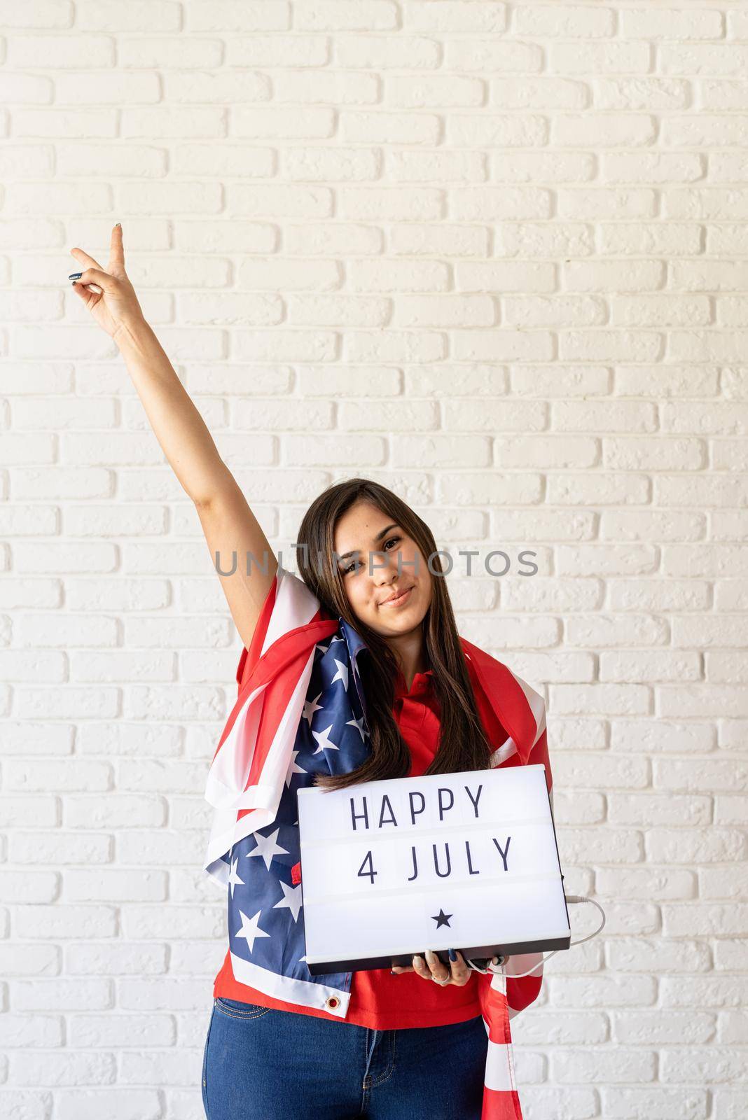 woman with american flag holding lightbox with words Happy 4 July by Desperada