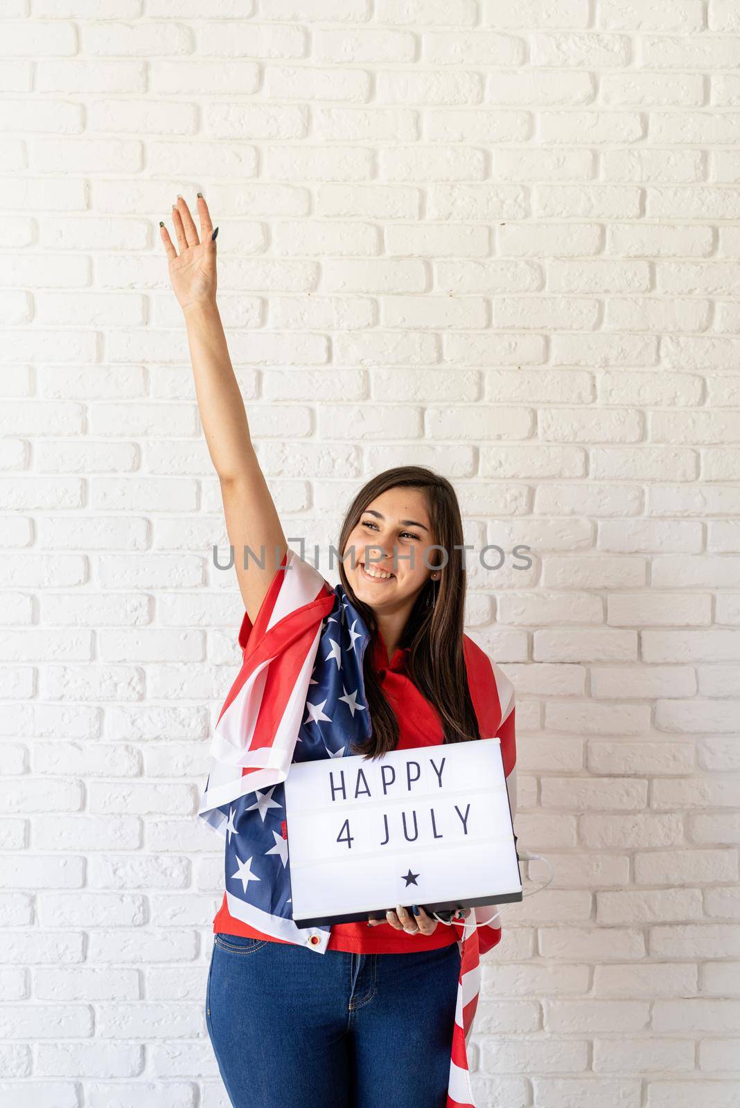 woman with american flag holding lightbox with words Happy 4 July by Desperada
