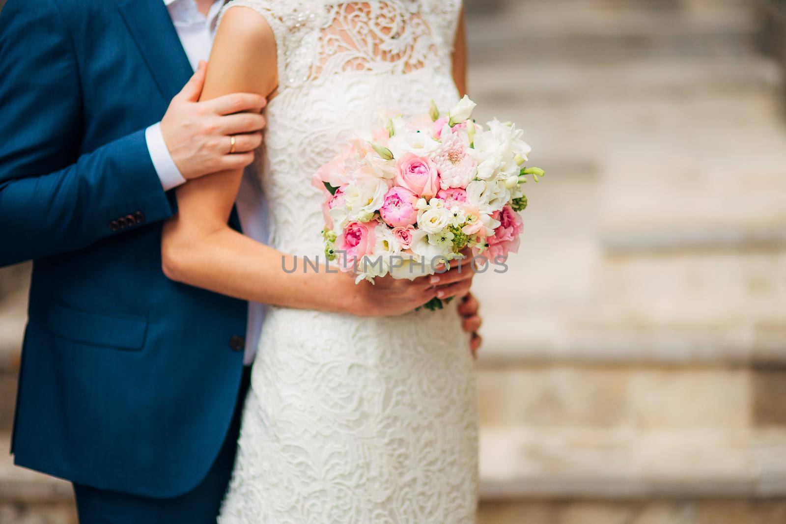 Wedding bouquet in hands of the bride by Nadtochiy