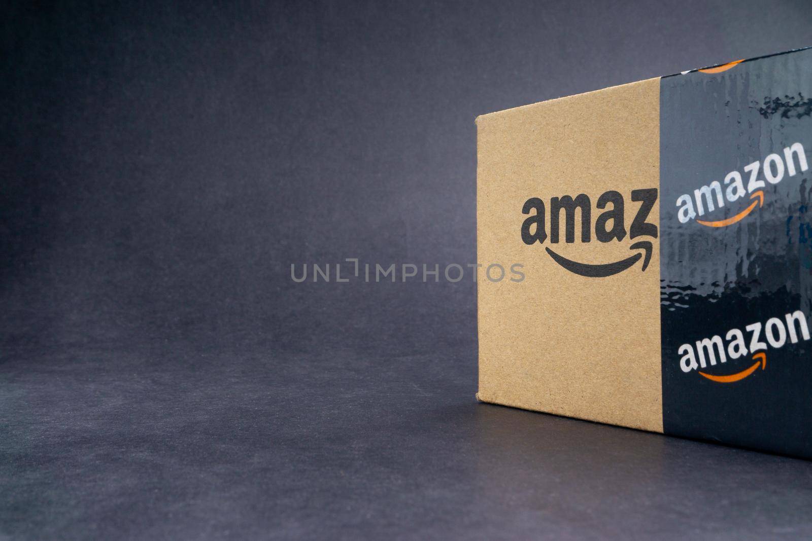 Kuala Lumpur, Malaysia - April 1, 2020 : Amazon Prime box or Amazon shipping box on black background. Crop fragment, business concept