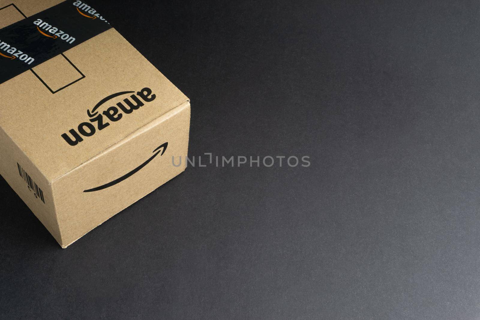 Kuala Lumpur, Malaysia - April 1, 2020 : Amazon Prime box or Amazon shipping box on black background. Crop fragment, business concept