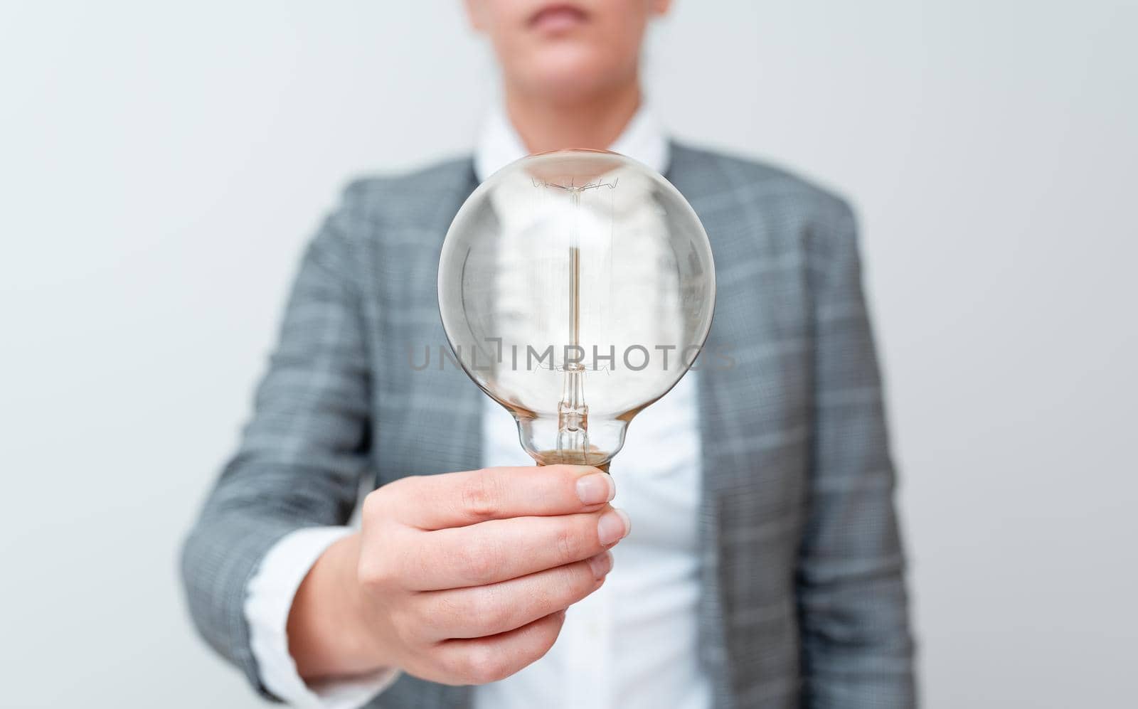 Lady Holding Lamp With Formal Outfit Presenting New Ideas For Project, Business Woman Showing Bulb With One Hand Exhibiting New Technologies, Lightbulb Presenting Another Openion.