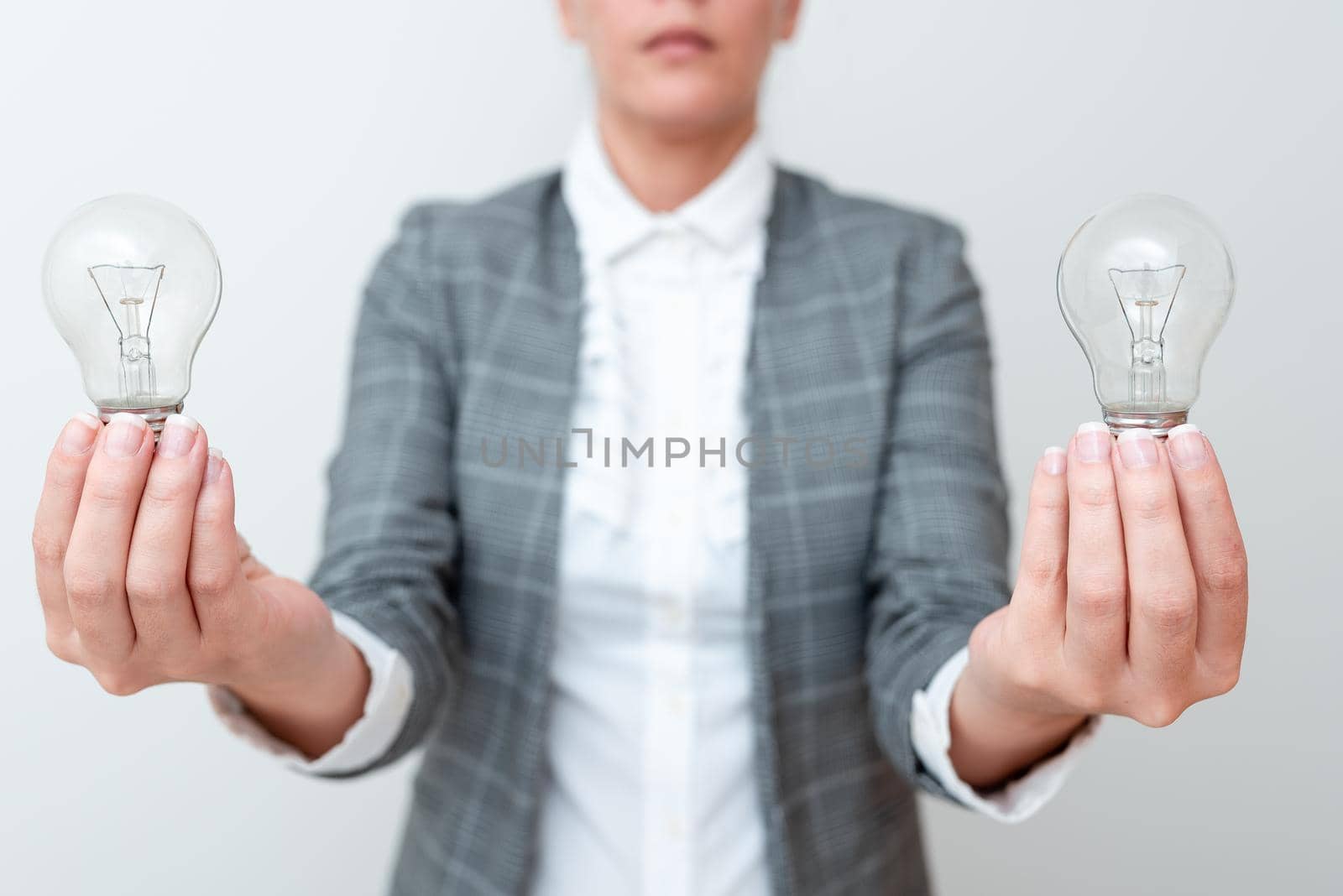 Lady Carrying Two Lightbulbs In Hands With Formal Outfit Presenting Another Ideas For Project, Business Woman Holding 2 Lamps Showing Late Technologies, Lighbulbexhibiting Fresh Openion.