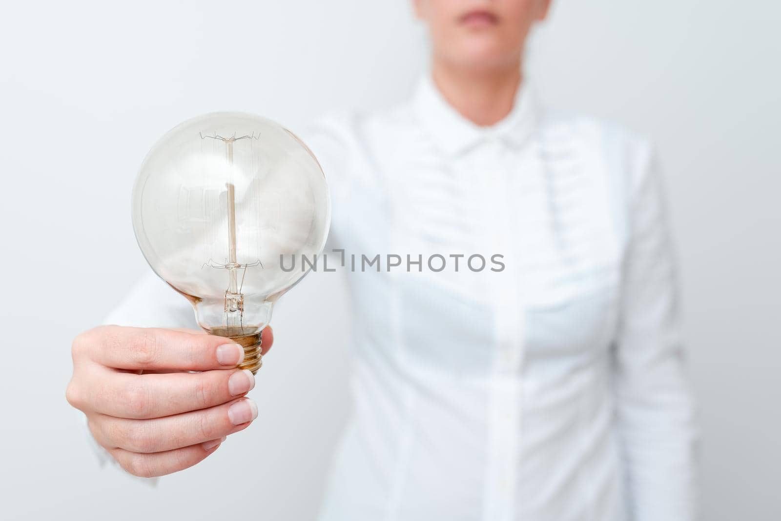 Lady Holding Lamp With Formal Outfit Presenting New Ideas For Project, Business Woman Showing Bulb With One Hand Exhibiting New Technologies, Lightbulb Presenting Another Openion.