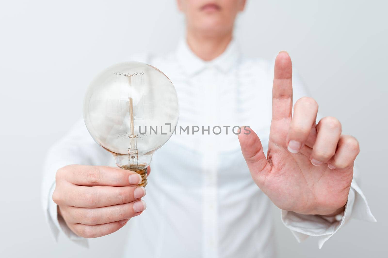 Lady Pointing At Screen Holdnig Lamp In Formal Outfit Presenting New Ideas For Project, Business Woman And Spotting Monitor With Bulb Showing Late Technologies.