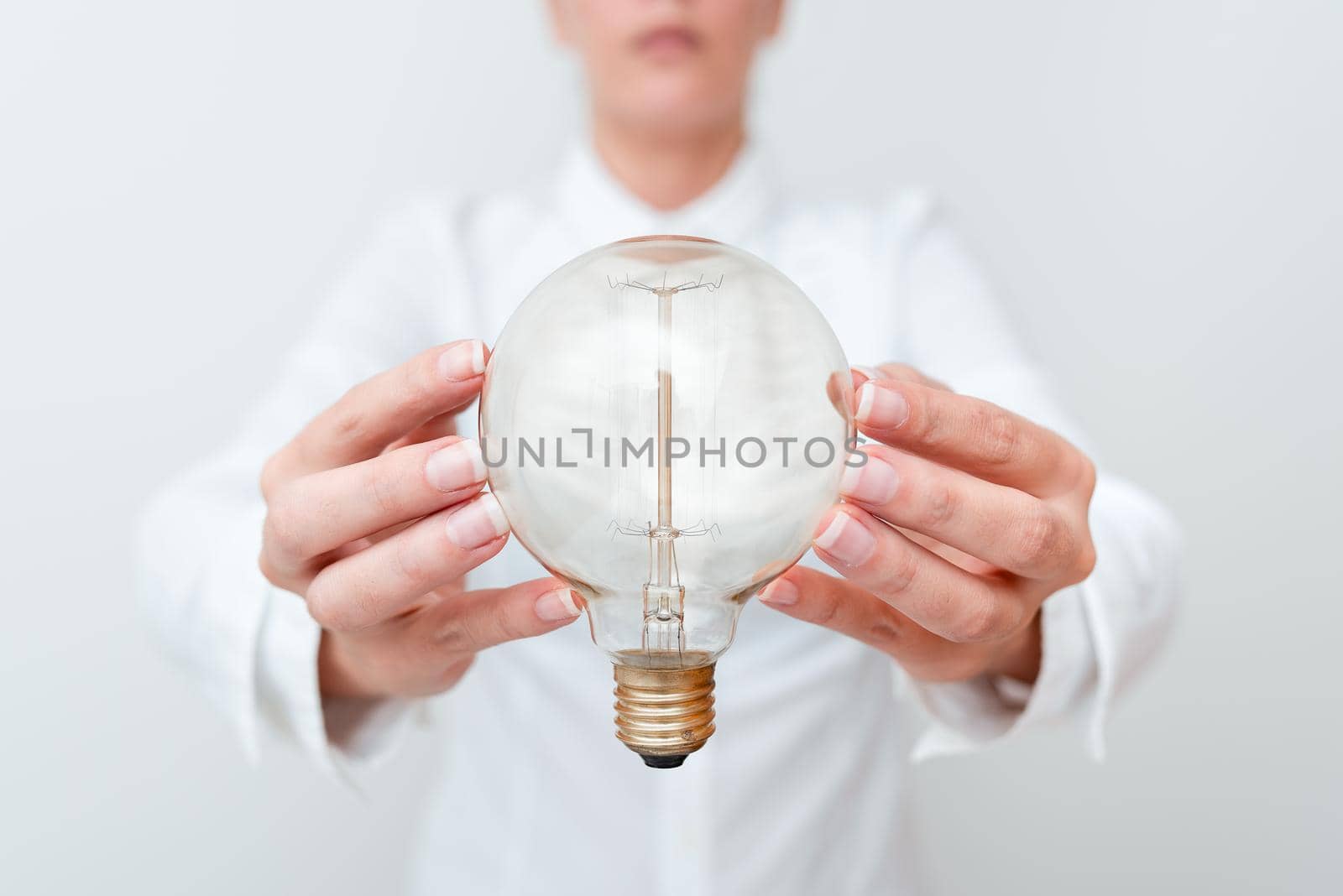 Lady Holding Lamp With Formal Outfit Presenting New Ideas For Project, Business Woman Showing Bulb With Two Hands Exhibiting New Technologies, Lightbulb Presenting Another Openion.