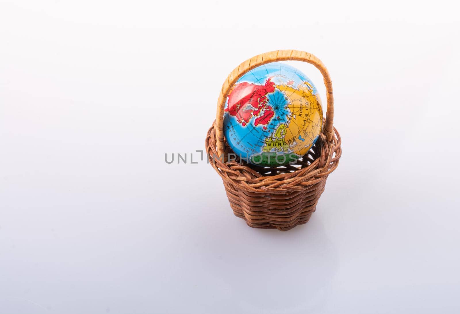 Little model globe in a basket in view