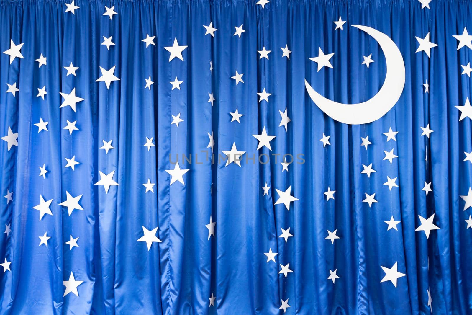 Blue background from matter with white stars and moon.