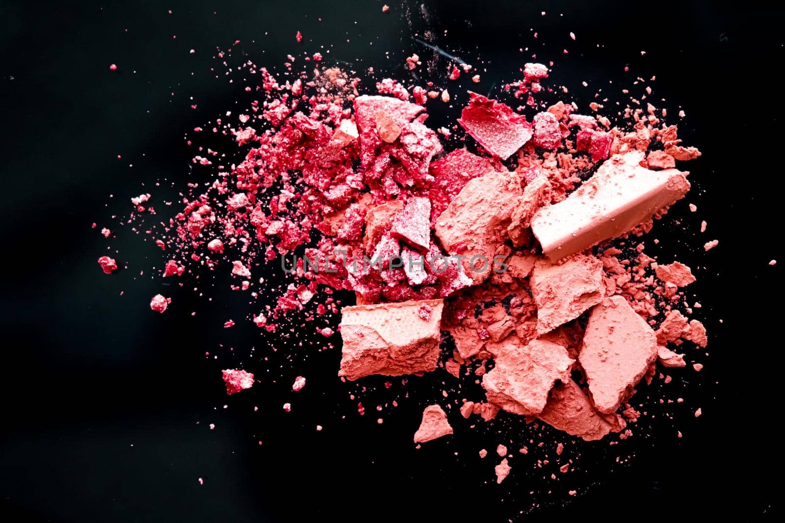 Crushed cosmetics, mineral organic eyeshadow, blush and cosmetic powder isolated on black background, makeup and beauty banner, flatlay design.