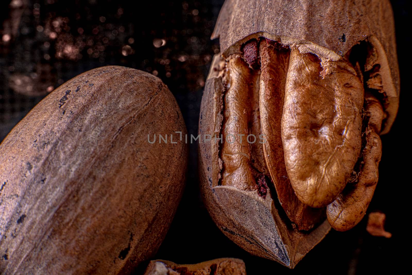 Dried pecan nuts and pecan nut's shells on a wooden table, close up, macro photography. High quality photo