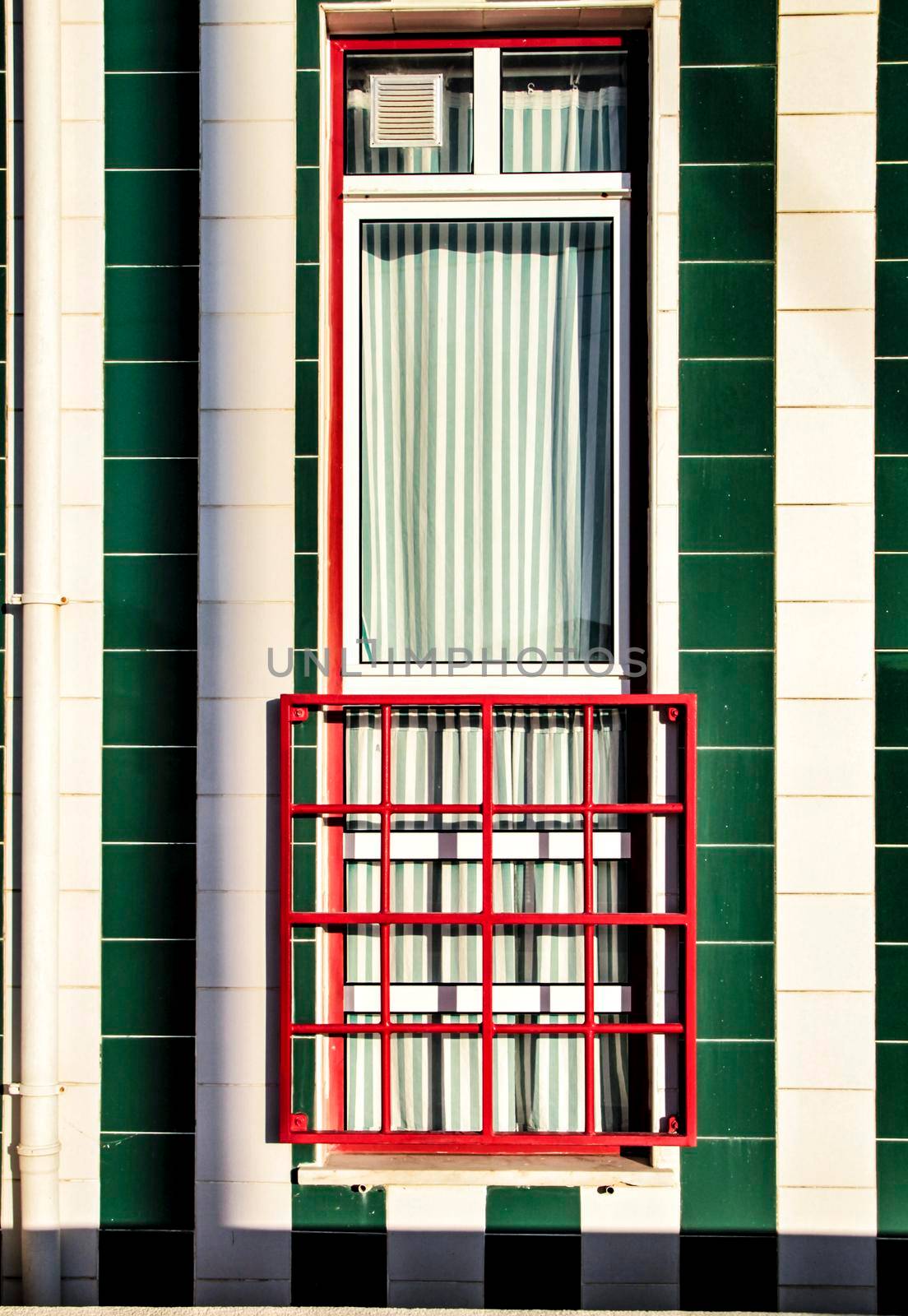 Beautiful and colorful striped facades in Costa Nova beach in Aveiro, Porto, Portugal.