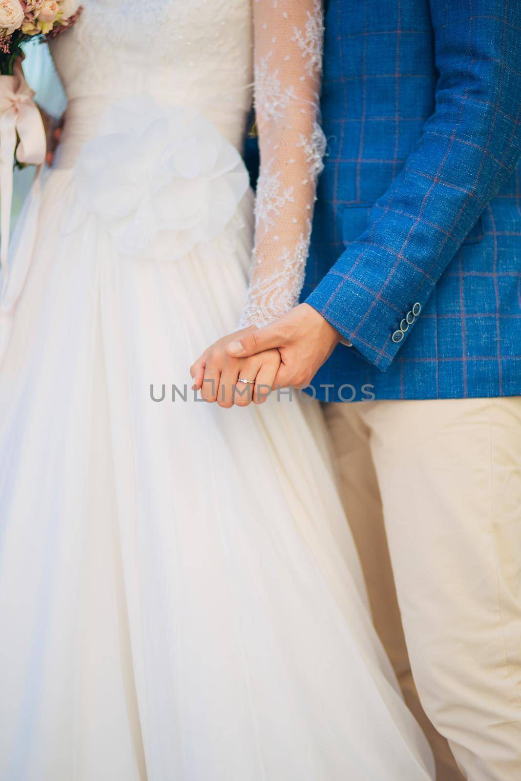 Bride and groom holding hands. Wedding in Montenegro