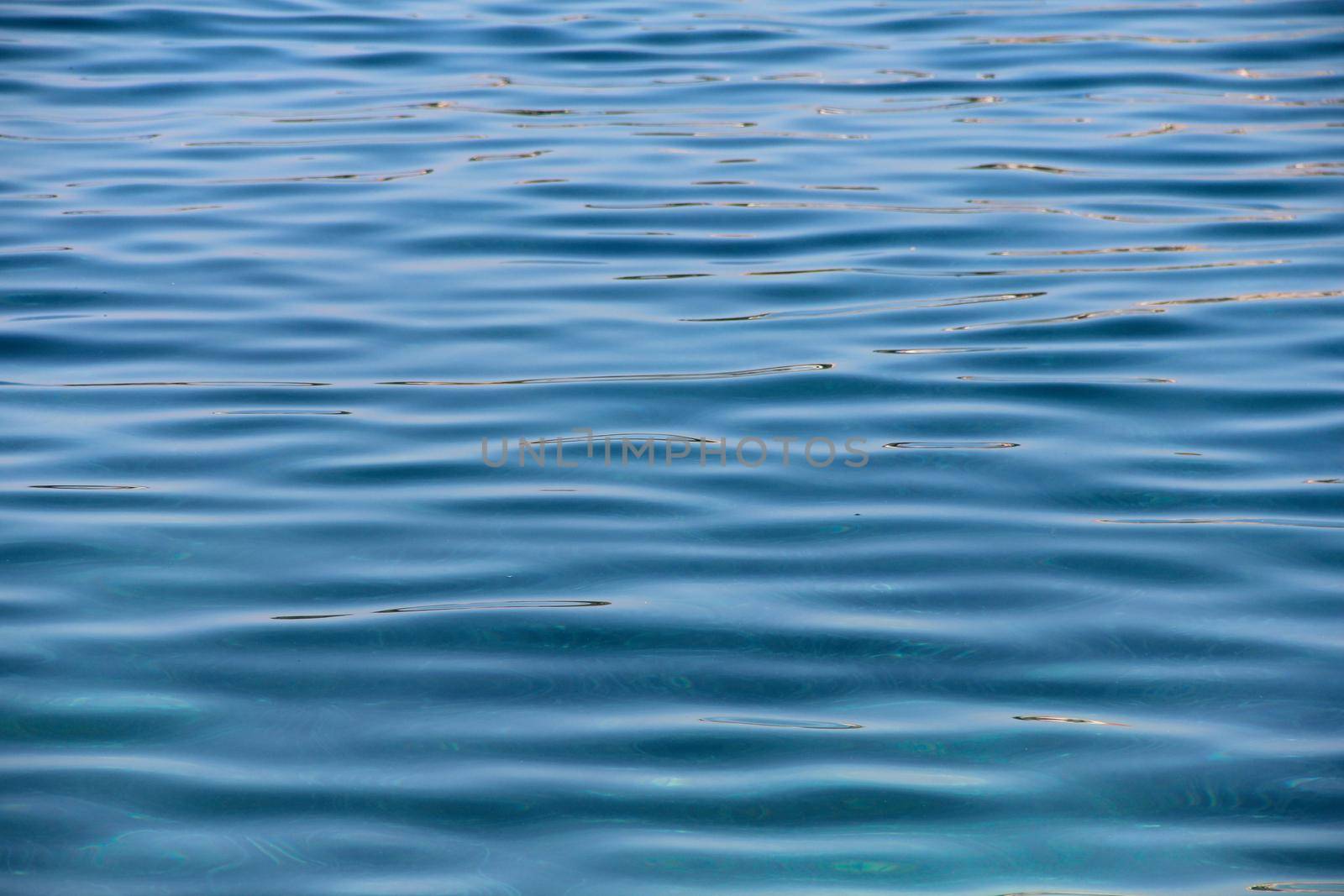 Sea water near beach natural background , white stone pebble beach in Croatia Sumartin Brac island pure transparent beautiful water