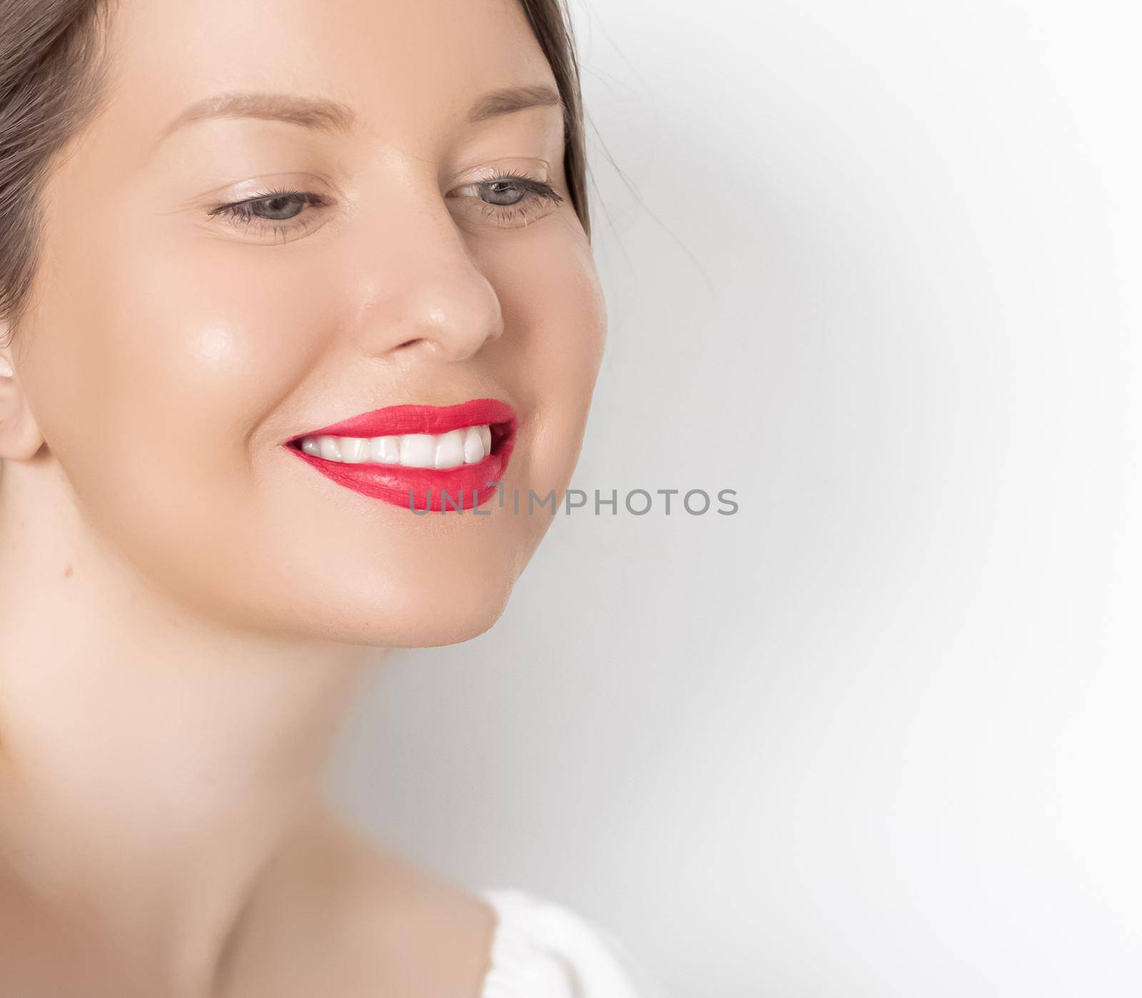 Happy smiling young woman with perfect white teeth and beautiful healthy smile, clean skin and natural makeup, female face portrait with positive emotion, beauty, wellness and skincare ad.