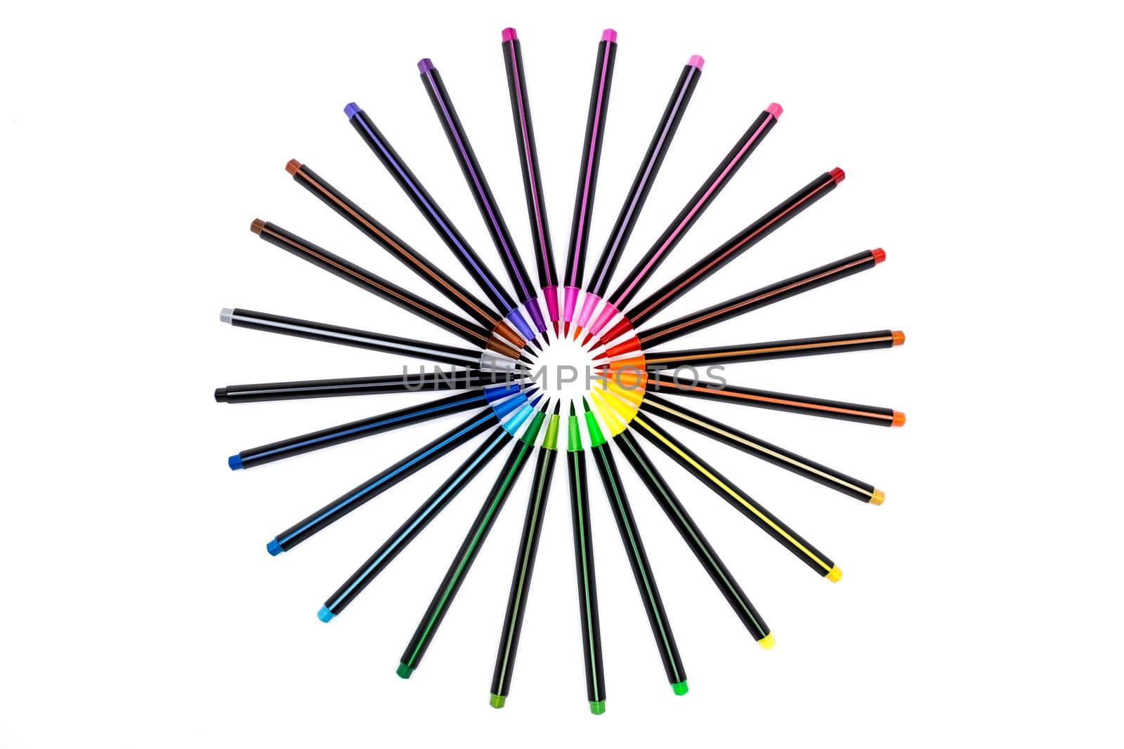A set of bright multi-colored felt-tip markers lie in a circle,