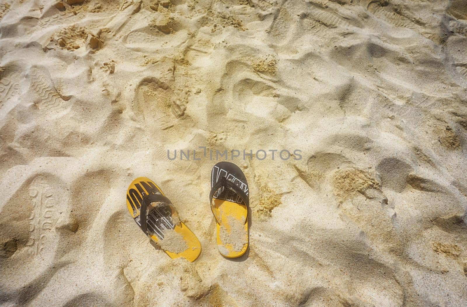 beach slippers on the golden sand by Roberto