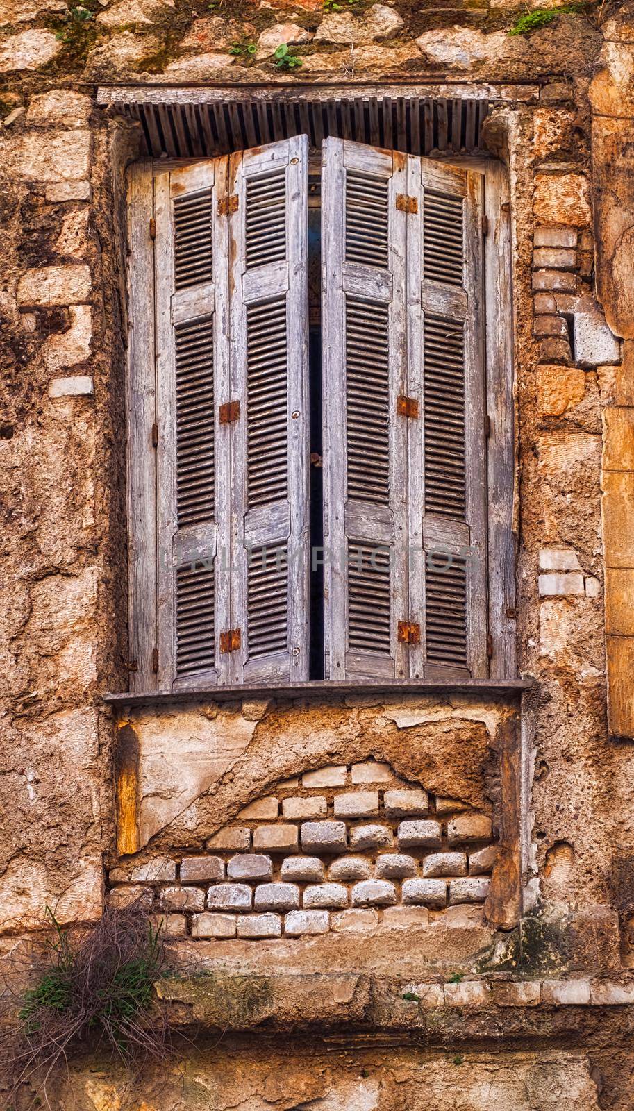 old house in disrepair, window close up by Roberto