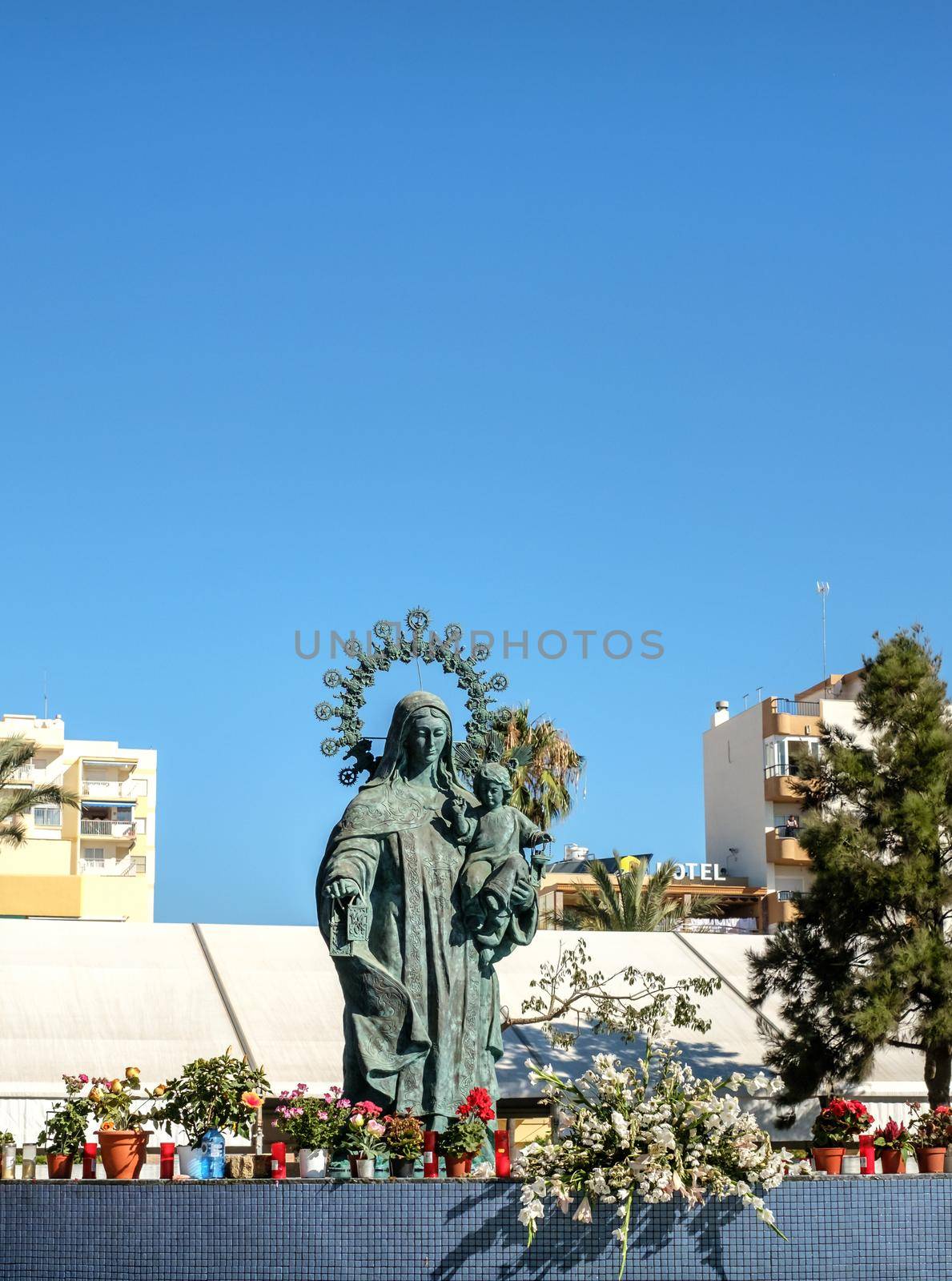 Torre del Mar, Spain - July 29, 2018 statue of Our Lady of Carmen with candles on the edge in center of Tore del Mar city, Malaga region, Spain