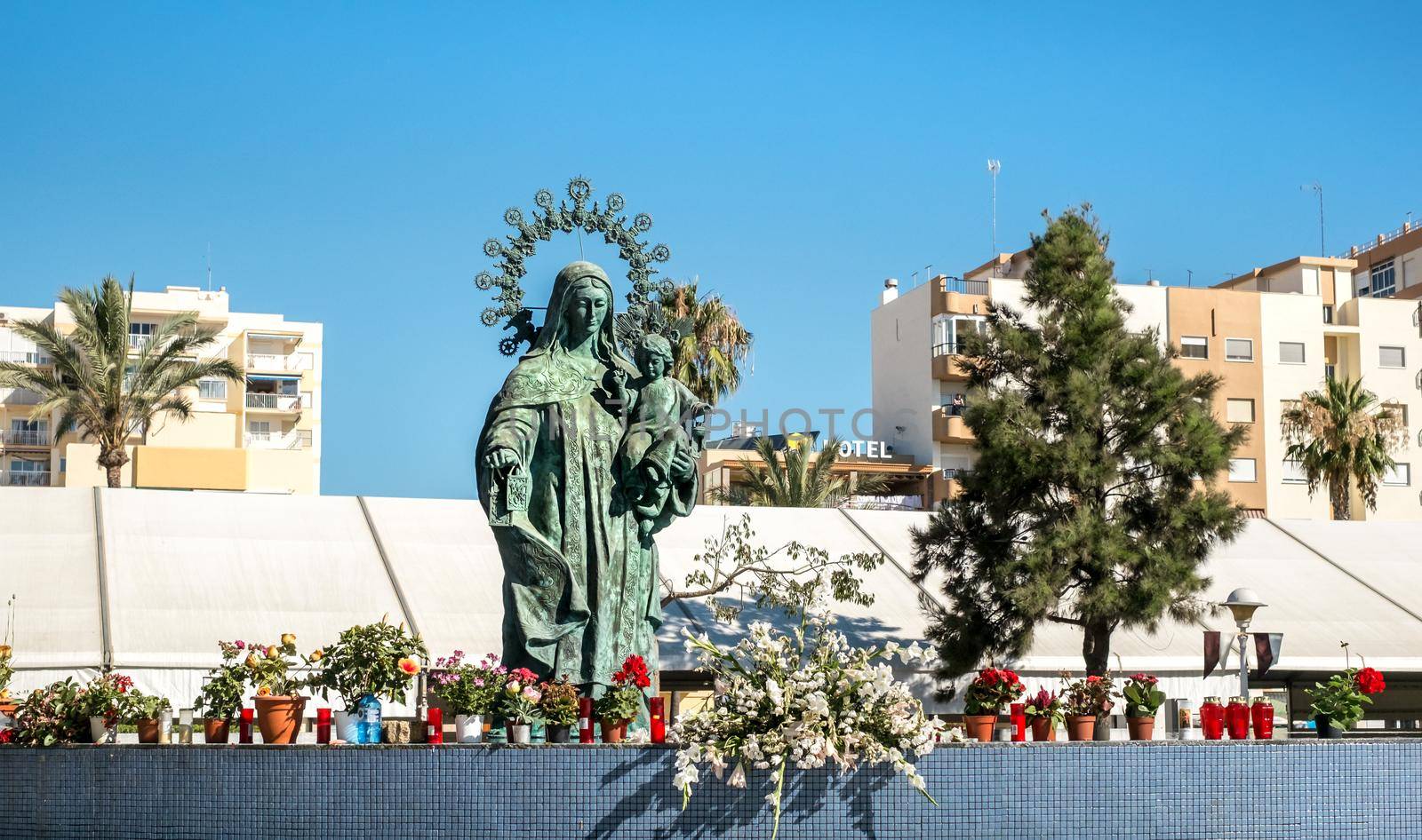 Torre del Mar, Spain - July 29, 2018 statue of Our Lady of Carmen with candles on the edge in center of Tore del Mar city, Malaga region, Spain