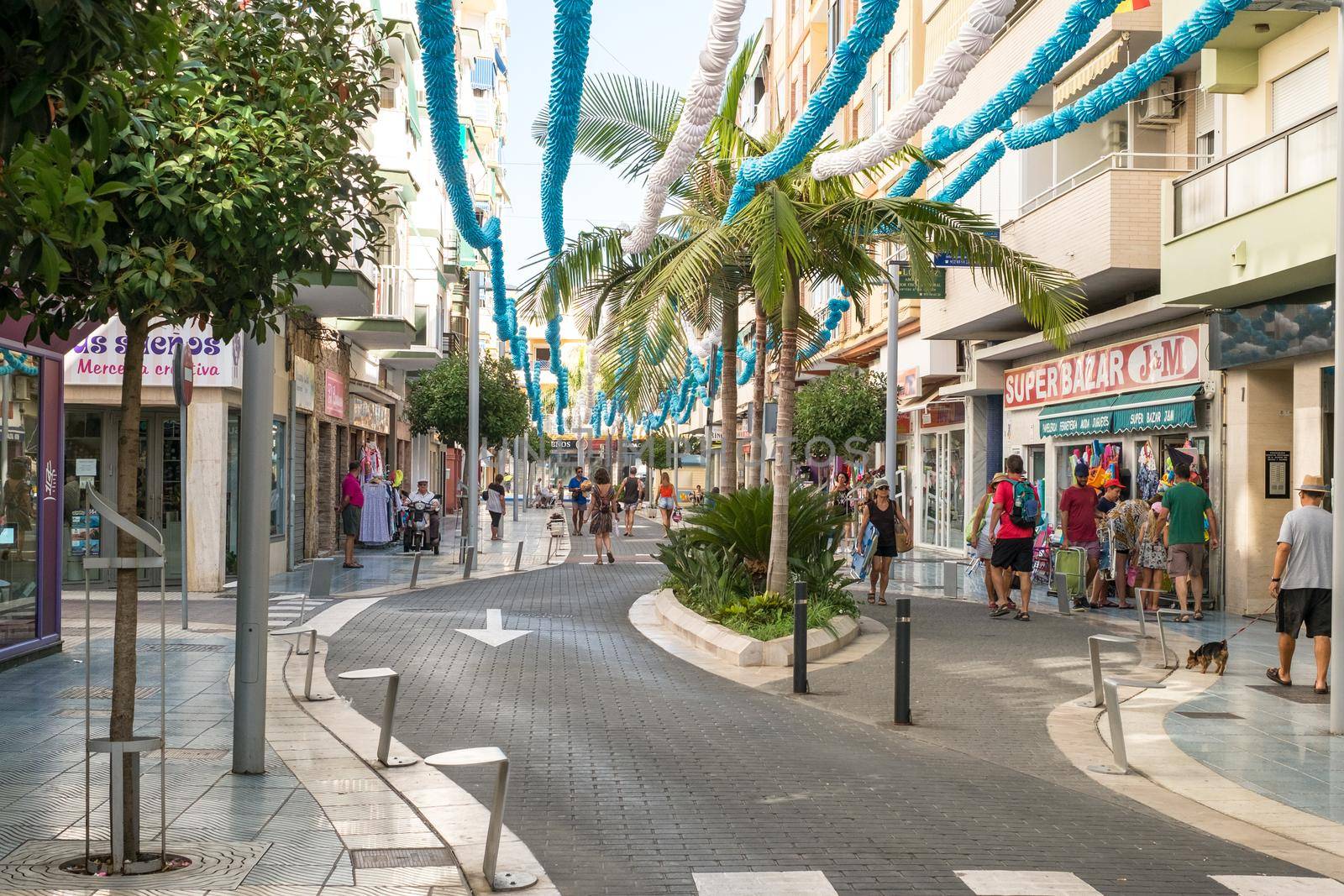 Torre del Mar, Spain - July 29, 2018. Tourists on the most beautiful street in Torre del Mar, Princesa street, Malaga region, Spain