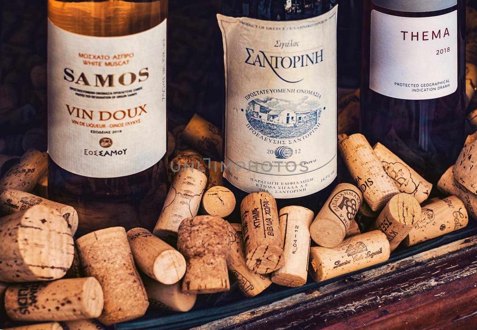 Athens, Greece - February 18, 2020. bottles of wine and Old Used corks plugs from different wine producing countries in a shop window